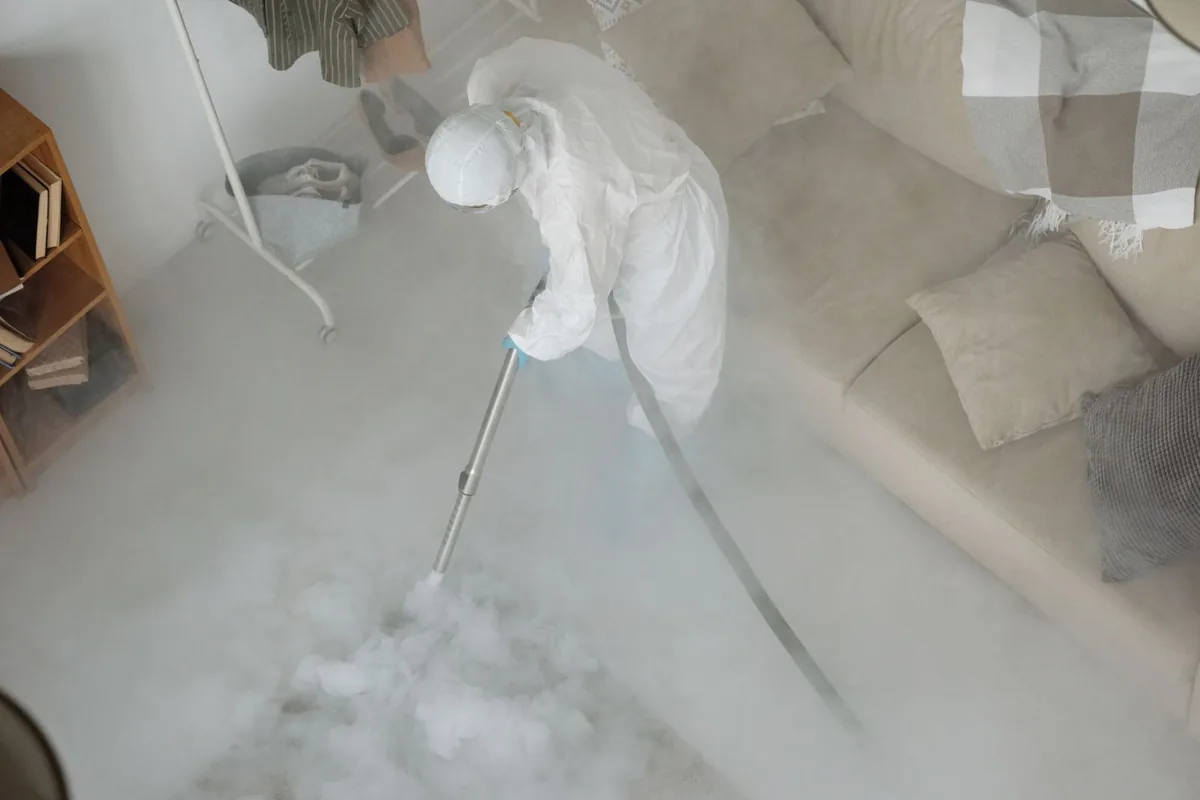 Biohazard cleanup technician in protective equipment, Dixon, NM